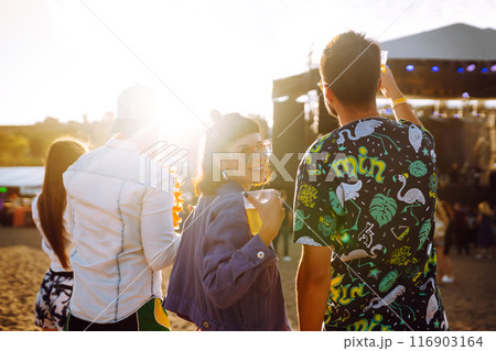 Group of friends with beer dancing and having fun at music festival together. Summer Beach party. Group of friends with beer dancing and having fun at music festival together. Summer Beach party. 116903164