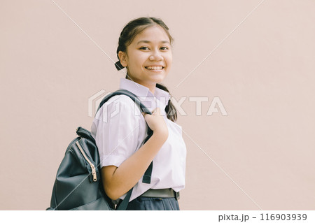 Portrait Thai Asian School girl teen cute student in uniform standing happy smile with shoulder bag isolated space for text. 116903939