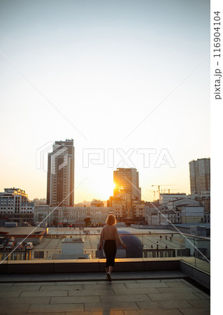 Young woman posing in roof, amazing view of city from roof. . Fashion, style concept. Lifestyle. 116904104