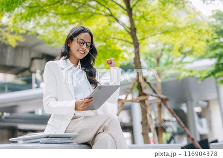 Success achievement people. Indian Business people happy hand rising working outdoor green city background. 116904378