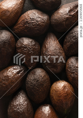Beautiful brown background of old avocados, top view. Art for interior decoration, a symbol of beauty in the aging of people and fruits. Beautiful brown background of old avocados, top view. Art for interior decoration, a symbol of beauty in the aging of people and fruits. 116905668