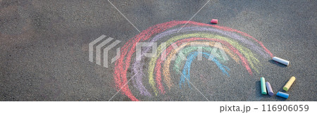 Sidewalk chalk drawing. A rainbow painted on the asphalt. Kids activities Sidewalk chalk drawing. A rainbow painted on the asphalt. Kids activities 116906059