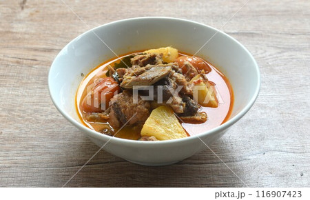 spicy boiled roasted duck meat with pineapple and tomato in coconut milk curry soup on bowl 116907423