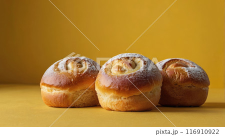 Freshly baked buns on a yellow background, selective focus. 116910922