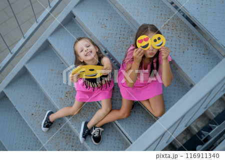 Funny humorous children demonstrate paper emoticons with a variety of emotions and moods Funny humorous children demonstrate paper emoticons with a variety of emotions and moods 116911340