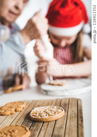 Closeup of baked cookies decorating with cream on background at Christmas 116911352