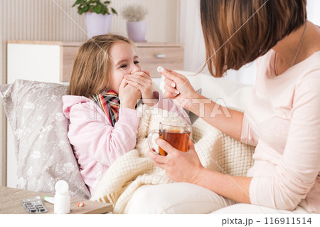 Little ill girl refuse to drink treatment pill 116911514