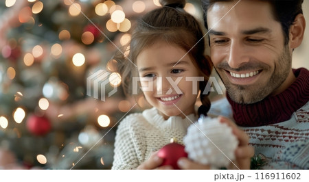 Father and Daughter Decorating Christmas Tree 116911602
