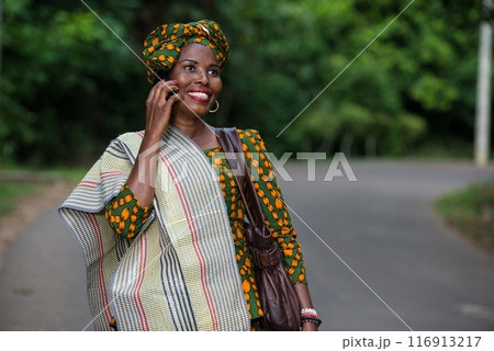 portrait of young african woman with mobile phone, smiling. 116913217