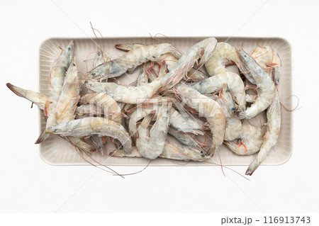 A dish with frozen shrimp isolated on a white background. 116913743