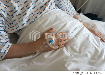 Focus on the hand of a patient in hospital ward. 116913782