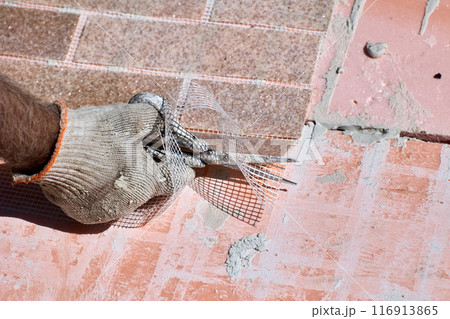 Thin flexible panel of artificial brick made of marble chips is reinforced with plastic mesh, which is cut with scissors during installation. 116913865