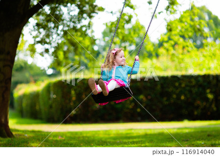 Kids explore nature. Children play in sunny park. 116914040