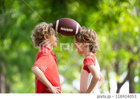 Family playing American football. Kids play rugby 116914053
