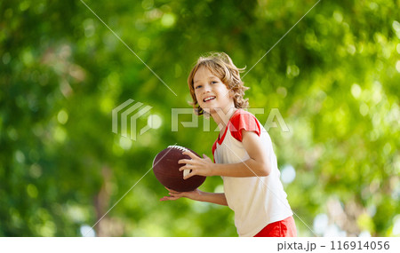 Family playing American football. Kids play rugby Family playing American football. Kids play rugby 116914056