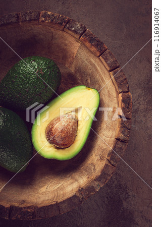 fresh, sliced avocado, in a wooden plate, top view, food background, concept, food styling 116914067