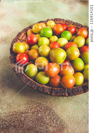 cherry plum tkemali, fruit, plum variety, in a wooden plate, Georgian cuisine, top view, no people, 116914101