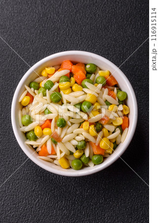 Delicious boiled rice with vegetables or risotto with carrots, peas and corn 116915114