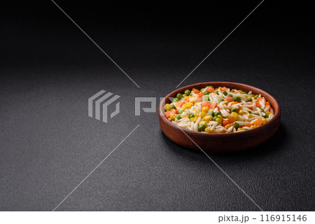 Delicious boiled rice with vegetables or risotto with carrots, peas and corn 116915146