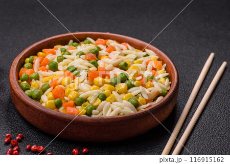 Delicious boiled rice with vegetables or risotto with carrots, peas and corn Delicious boiled rice with vegetables or risotto with carrots, peas and corn 116915162