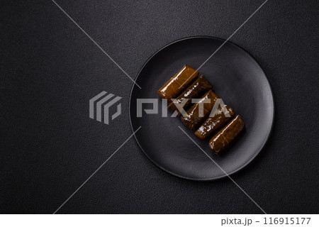 Delicious dolma in the form of rice and meat wrapped in grape leaves 116915177