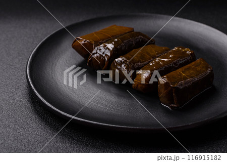 Delicious dolma in the form of rice and meat wrapped in grape leaves Delicious dolma in the form of rice and meat wrapped in grape leaves 116915182