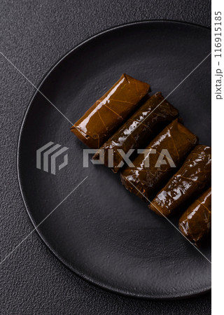 Delicious dolma in the form of rice and meat wrapped in grape leaves Delicious dolma in the form of rice and meat wrapped in grape leaves 116915185