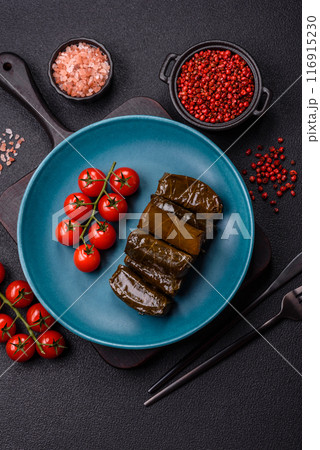 Delicious dolma in the form of rice and meat wrapped in grape leaves Delicious dolma in the form of rice and meat wrapped in grape leaves 116915230