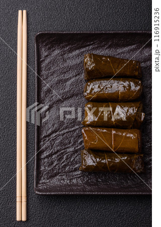 Delicious dolma in the form of rice and meat wrapped in grape leaves 116915236