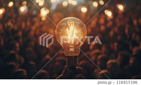 a light bulb in front of a crowd of people. 116915386