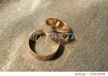 Gold wedding rings with ancient symbols. Gold jewelry. Latvian ancient symbols. Gold wedding rings with ancient symbols. Gold jewelry. Latvian ancient symbols. 116916046