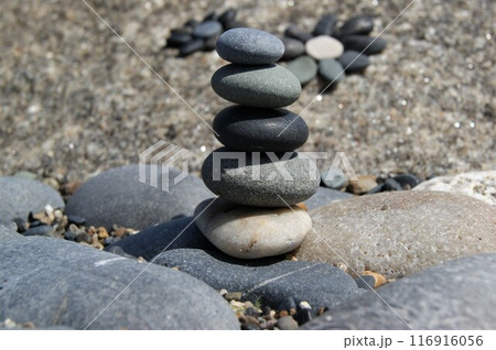 The subject is in focus, the background is blurred. Zen pyramid on rocks. The subject is in focus, the background is blurred. Zen pyramid on rocks. 116916056