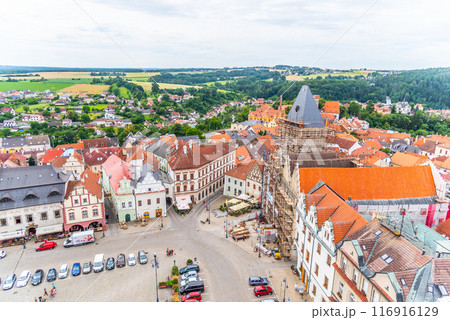 An overhead perspective showcasing Zizka Square with its historic buildings, parked cars, and lush surroundings on a cloudy day. Tabor, Czechia 116916129