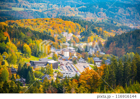 A scenic aerial view of Janske Lazne, framed by the vibrant autumnal colors of the surrounding Krkonose, Giant mountains. Czechia A scenic aerial view of Janske Lazne, framed by the vibrant autumnal colors of the surrounding Krkonose, Giant mountains. Czechia 116916144