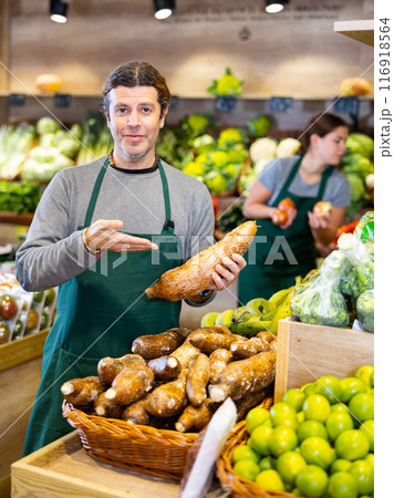 Adult man selling cassava in shop 116918564