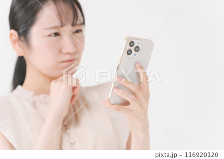 スマホを見て考える表情の女性 116920120