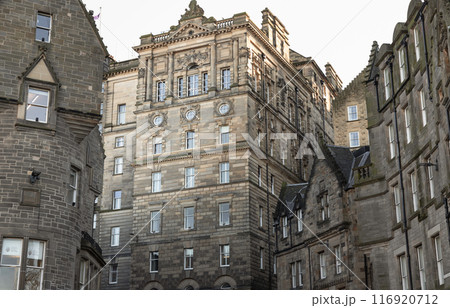 Charming facade of The Scotsman Hotel and ancient stone buildings in Baronial style on Cockburn Street. 116920712