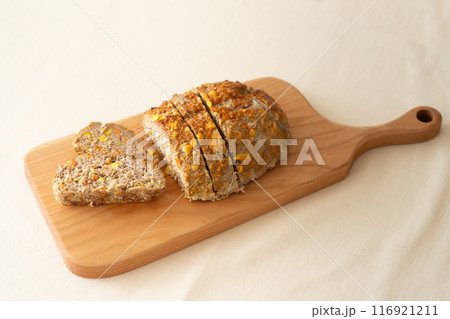 木のカッティングボードと野菜入りミートローフ 116921211