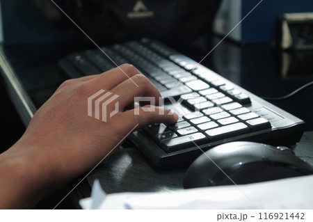 Hands of an office man typing 116921442