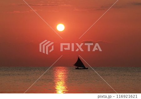 Beautiful sunrise on the sea and silhouette of a fishing boat 116921621