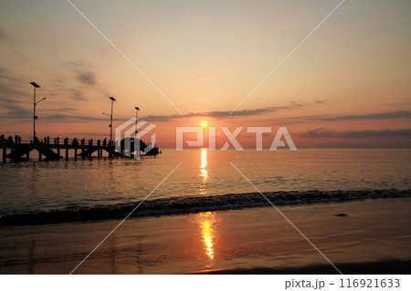 sunrise on the beach pier bridge with a clear sky 116921633