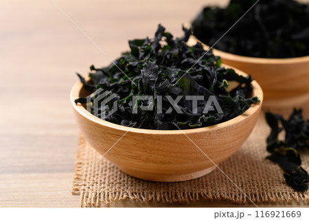 Dried Wakame seaweed or sea mustard in wooden bowl Dried Wakame seaweed or sea mustard in wooden bowl 116921669