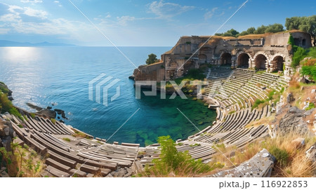 An ancient hillside amphitheater overlooks a calm, azure ocean, blending nature and history majestically. An ancient hillside amphitheater overlooks a calm, azure ocean, blending nature and history majestically. 116922853