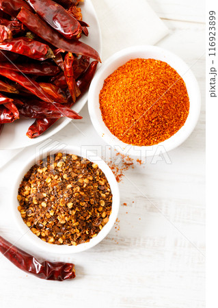 Dried red chilies on white wooden table. 116923899