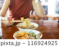 Woman hands holding delicious egg noodle with chopsticks 116924925