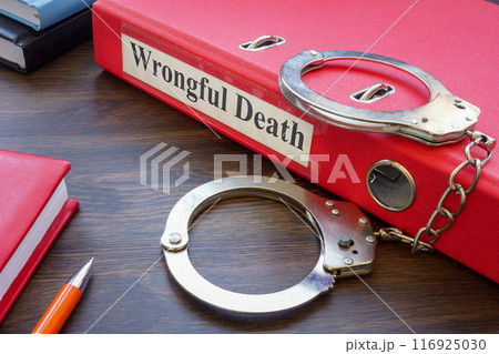 Folder about wrongful death and handcuffs. 116925030