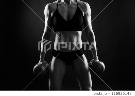 Back view of female model posing in studio and demonstrating comfortable activewear. 116926145