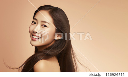 Portrait of a beautiful, sexy, happy smiling Asian woman with long hair, with perfect skin, creamy beige background, banner. 116926813