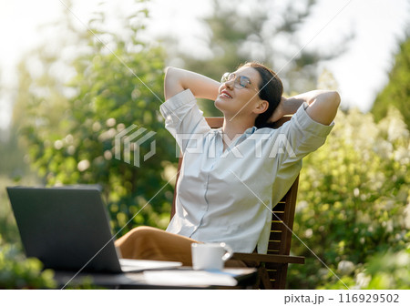 woman working on laptop in summer morning 116929502