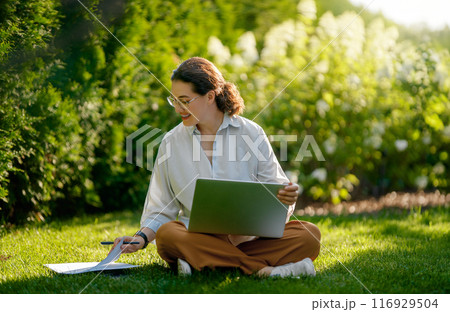 woman working on laptop in summer morning 116929504